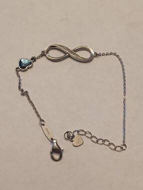 Sterling Silver Infinity Bracelet with Blue Heart Accent